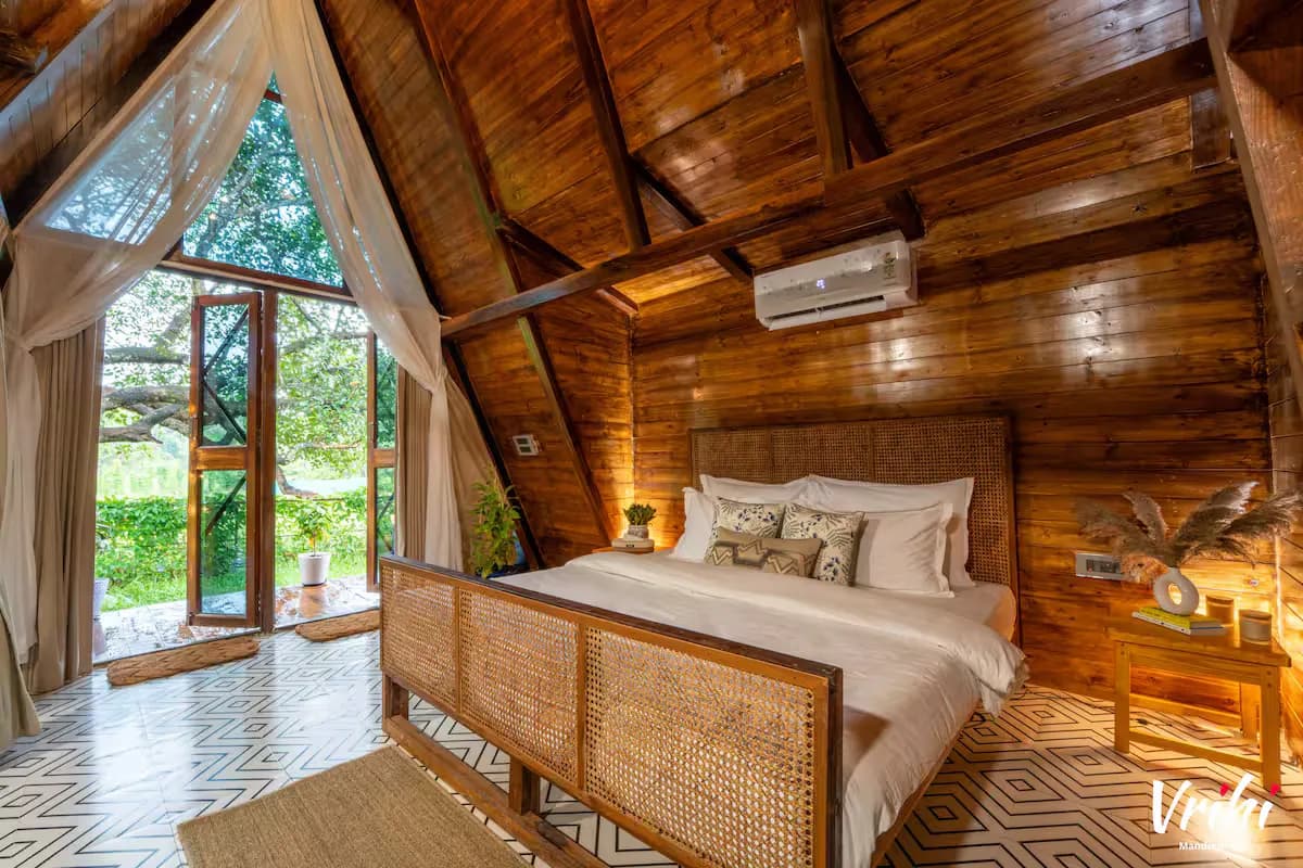 The ground-floor king bed, opening onto green