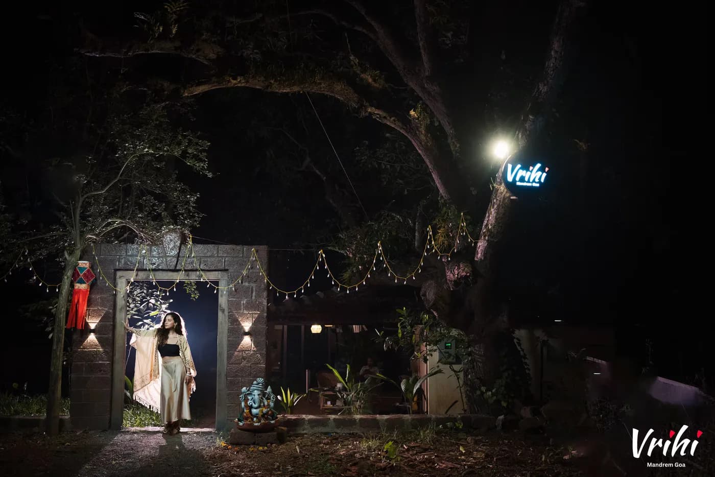 The entrance after dark, under the old tree