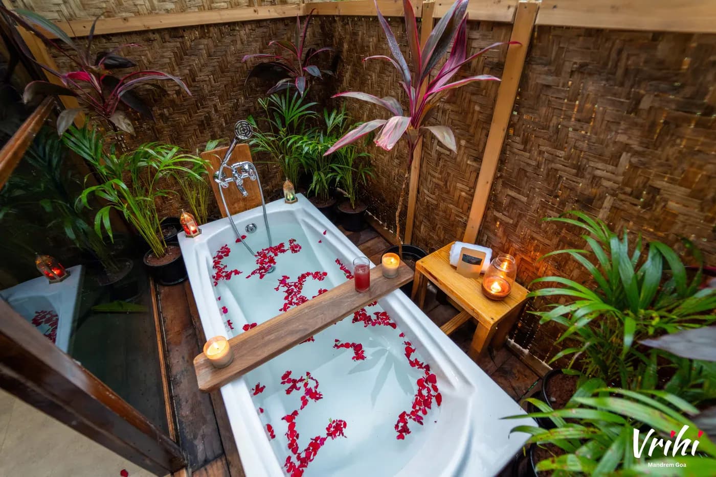 The open-air bathtub, walled in laterite and planting