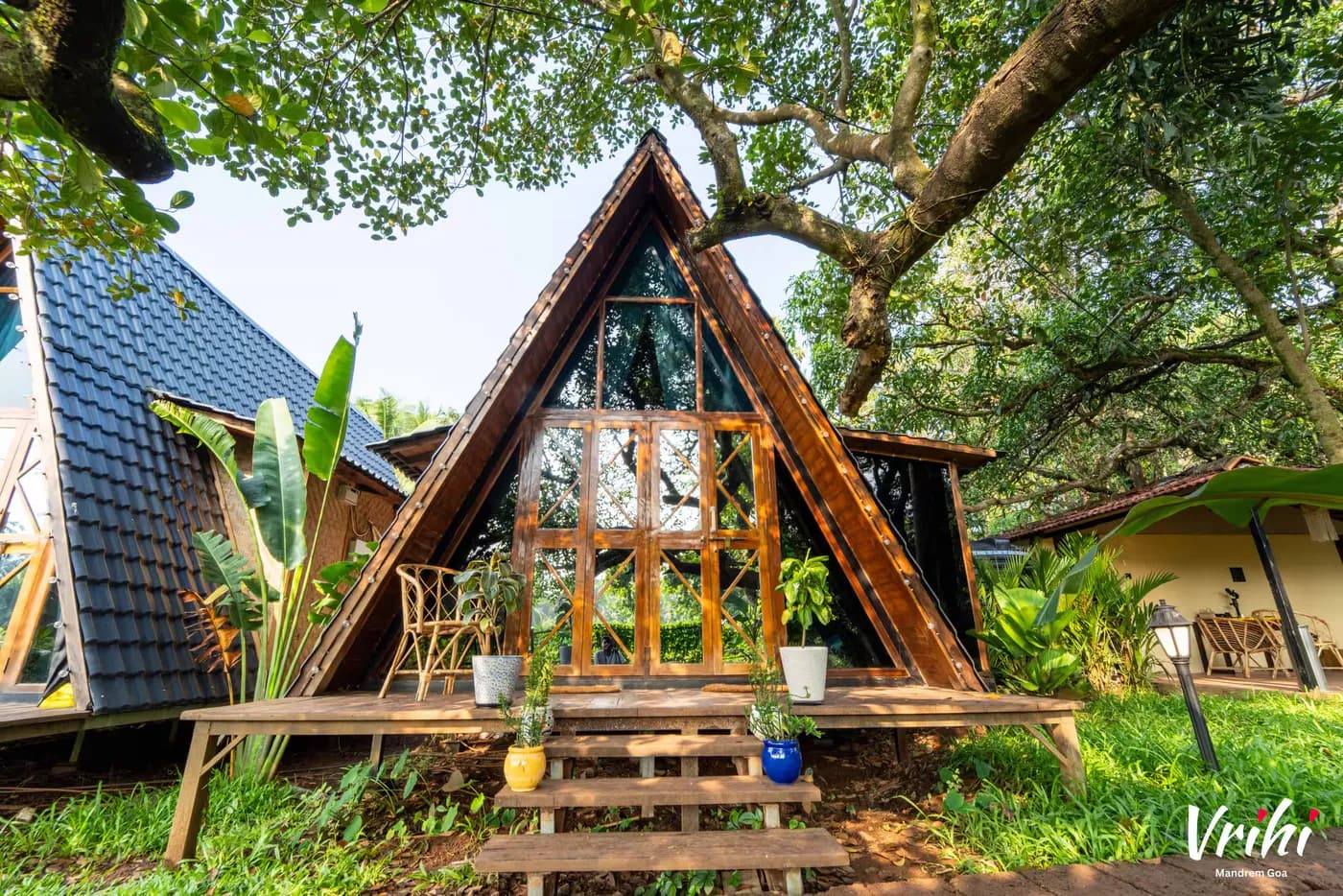 The cottage on its deck beneath the canopy